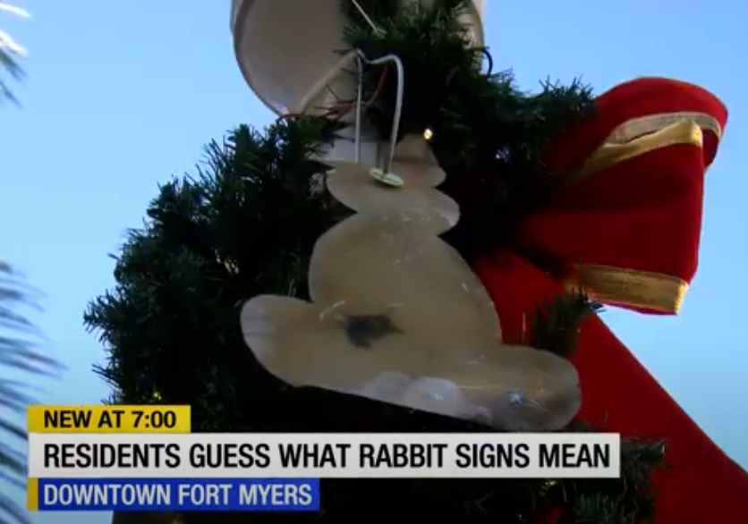 Another photo of the same news report, with a rabbit hidden under some city Christmas decorations.